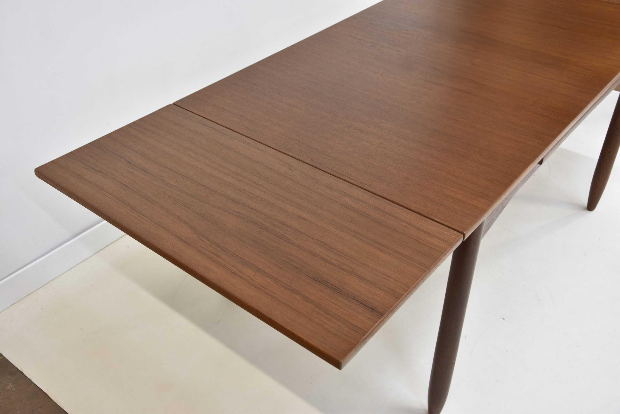 Table à rallonge vintage en teck, idéale pour salle à manger, avec design épuré et matériaux durables. Parfaite pour accueillir famille et amis lors de repas conviviaux.