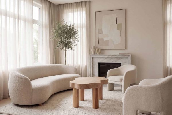 Photo d'un salon contemporain avec canapé, fauteuils et cheminée dans un intérieur lumineux et minimaliste.